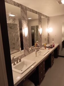 New tile with custom mirrors and two vanities .