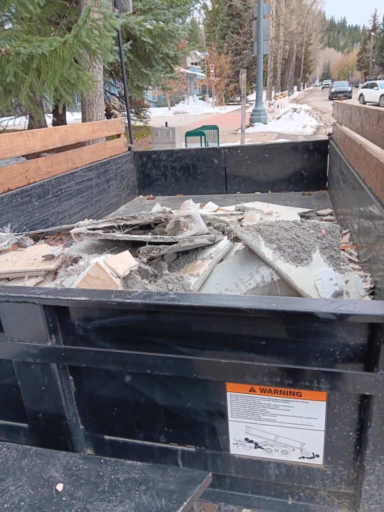 A dump trailer in Aspen west end sits with construction debris ready for removal.